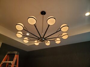 A modern chandelier with multiple globe lights installed on a ceiling by Small Jobs Electric in Tampa, FL.