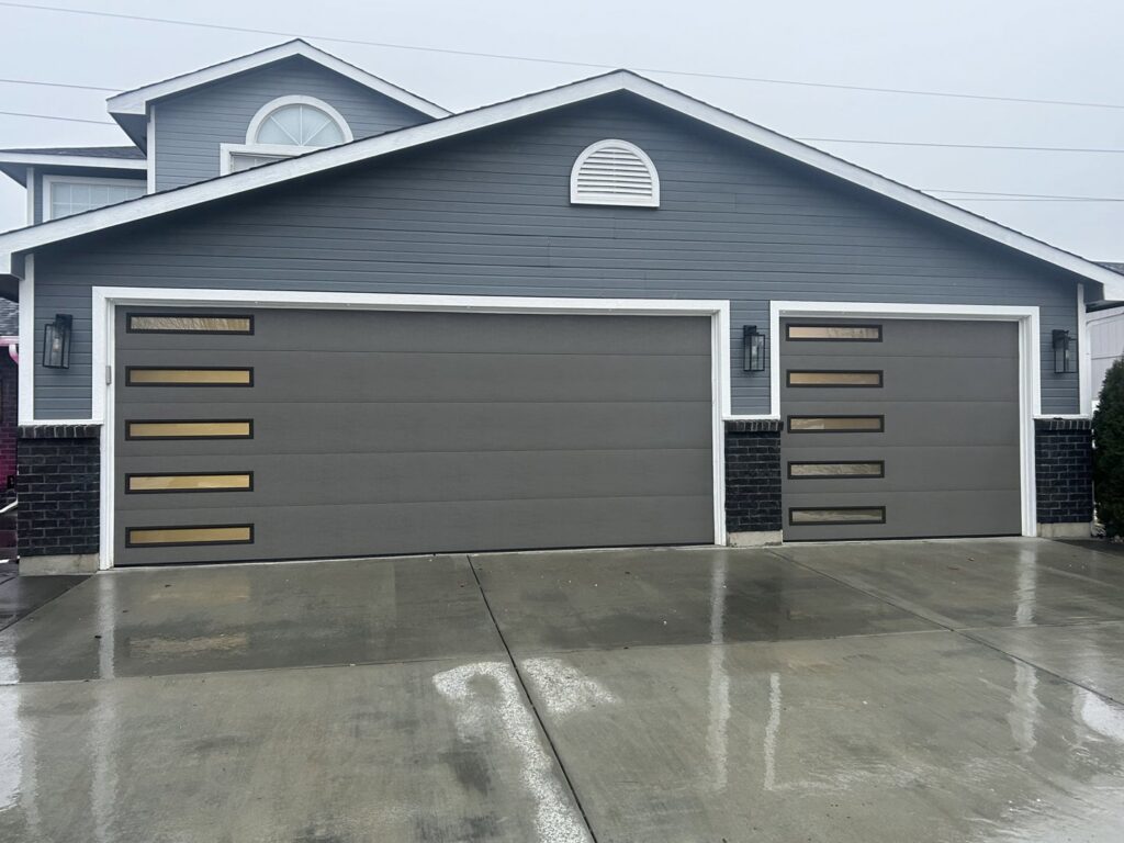 Two modern gray garage doors with horizontal windows installed by Discount Garage Door Company in Spokane, WA.
