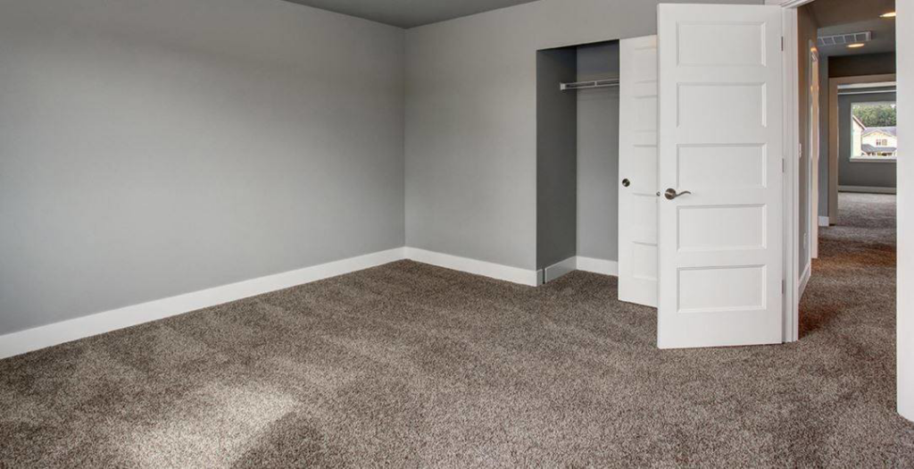 A modern grey carpet professionally installed in an empty room by Flooring Cleveland - Ohio City in Cleveland, OH.
