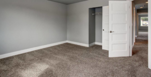 A modern grey carpet professionally installed in an empty room by Flooring Cleveland - Ohio City in Cleveland, OH.