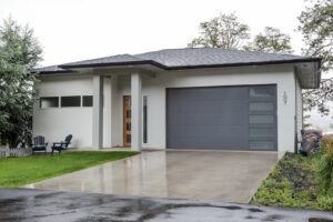 Modern grey garage door with horizontal windows on a contemporary home, installed by Continental Door Company, Spokane Valley, WA.