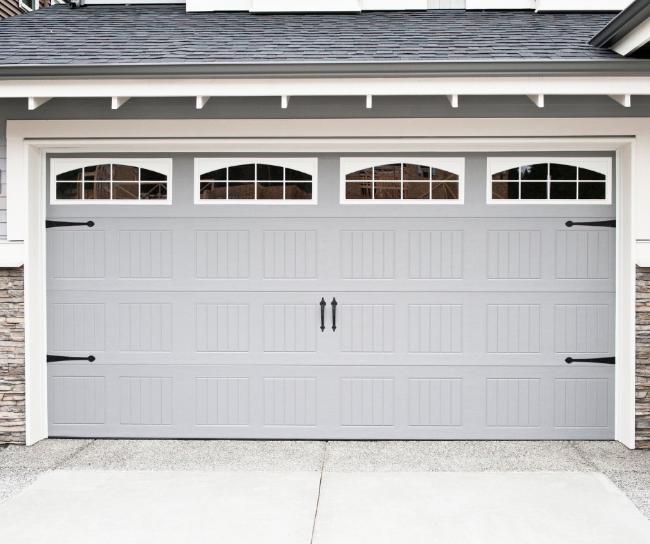 A modern grey garage door with decorative hardware, expertly installed by SS Garage Door Repair in Denver, CO.