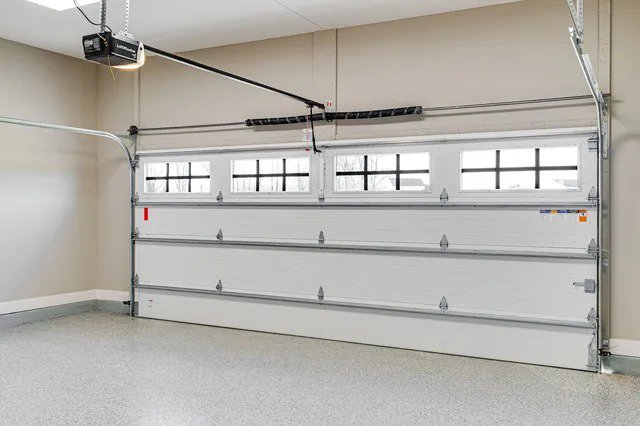 A sleek modern grey sectional garage door on a contemporary building, installed by Your Other Front Door LLC in Lakewood, CO.
