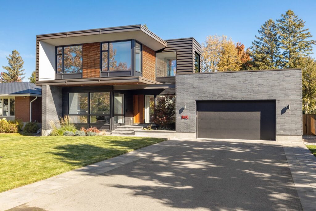 A modern home featuring a stylish black garage door, installed with precision by Rainier Garage Door in Bellevue, WA.