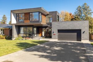 A modern home featuring a stylish black garage door, installed with precision by Rainier Garage Door in Bellevue, WA.