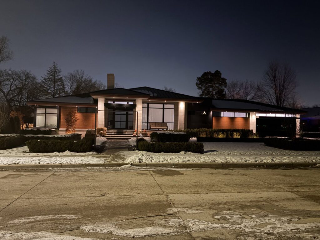 Modern home exterior illuminated by extensive outdoor lighting installed by Electric R US LLC in Dearborn, MI.