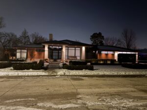 Modern home exterior illuminated by extensive outdoor lighting installed by Electric R US LLC in Dearborn, MI.