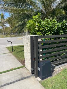 A modern horizontal-slat gate with a Viking gate operator motor installed by Motor & Fence Solutions in Miami, FL.