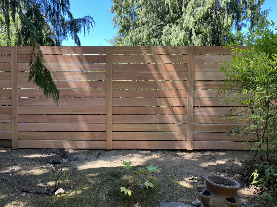 A modern horizontal slat wood fence installed by Webb Fencing Pros in Seattle, WA.