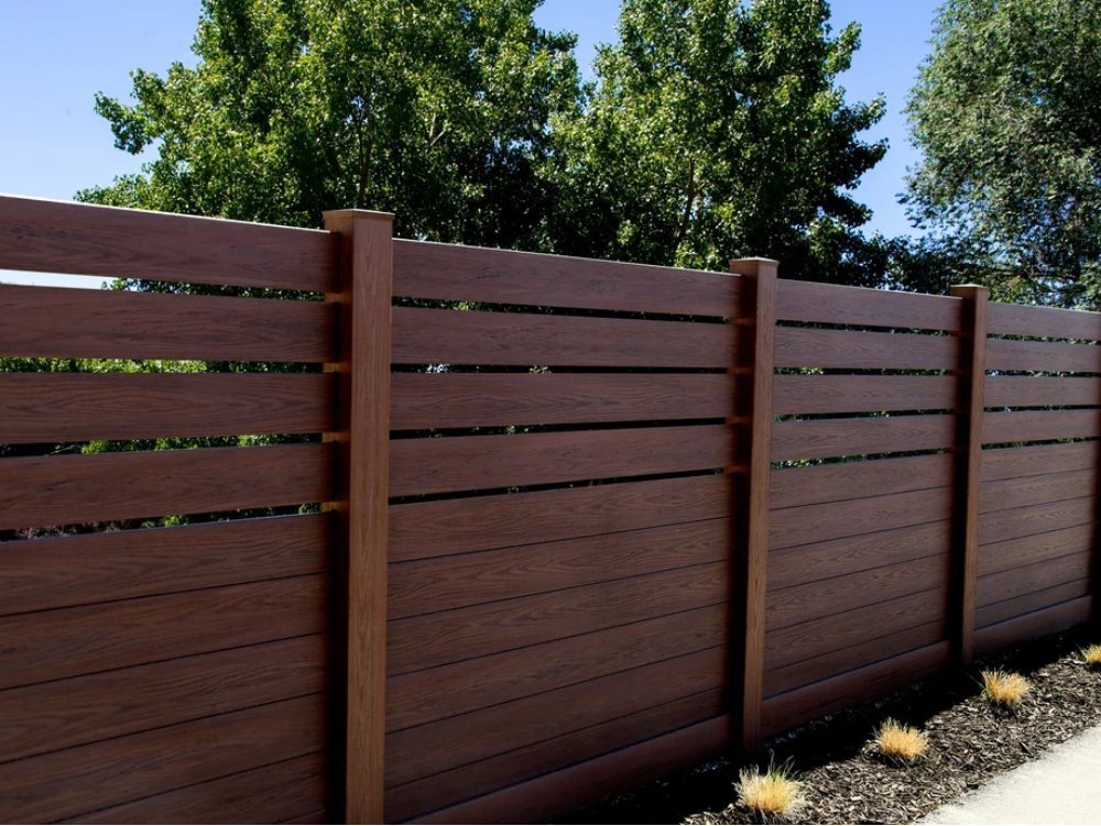 A modern horizontal wood-look fence providing privacy, installed by Ace Fence Company in Fort Lauderdale, FL.