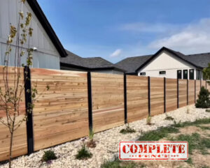 A modern horizontal wood fence with black posts installed by Complete Fence, LLC in West Chicago, IL