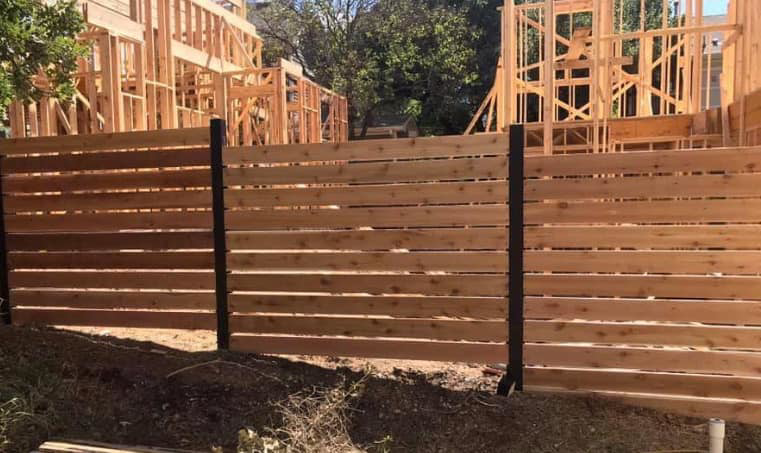 A modern horizontal slat wood fence installed by Pick-It Fences LLC, serving Pflugerville, TX.