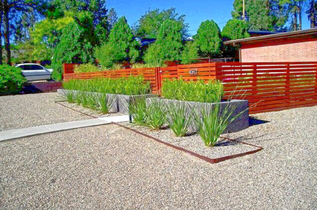 A modern horizontal wood fence with integrated planters in a front yard, installed by Ozark Fence in Lakewood, CO.