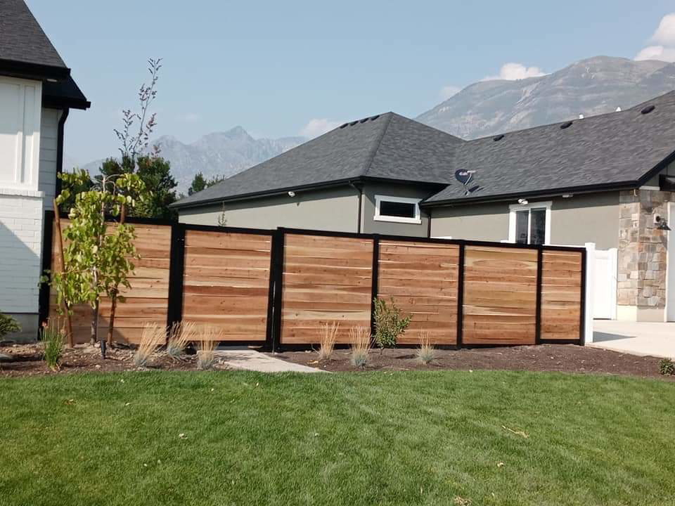 A modern horizontal wood privacy fence installed in a residential yard by Global Supply in Lindon, UT.