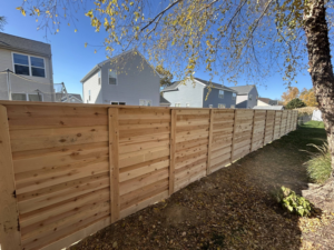 A modern horizontal wood slat fence installed in a residential backyard by Walker Fence in Council Bluffs, IA.