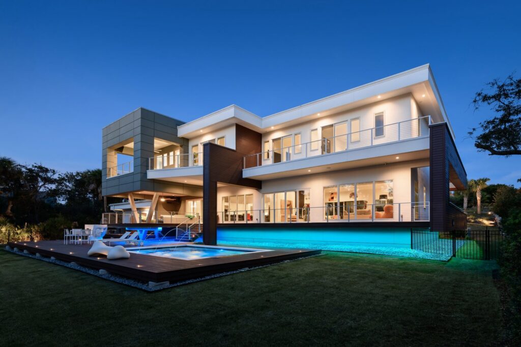 Modern house exterior with extensive outdoor and indoor lighting installed by Performance Electrical Contracting Inc. in Jacksonville, FL