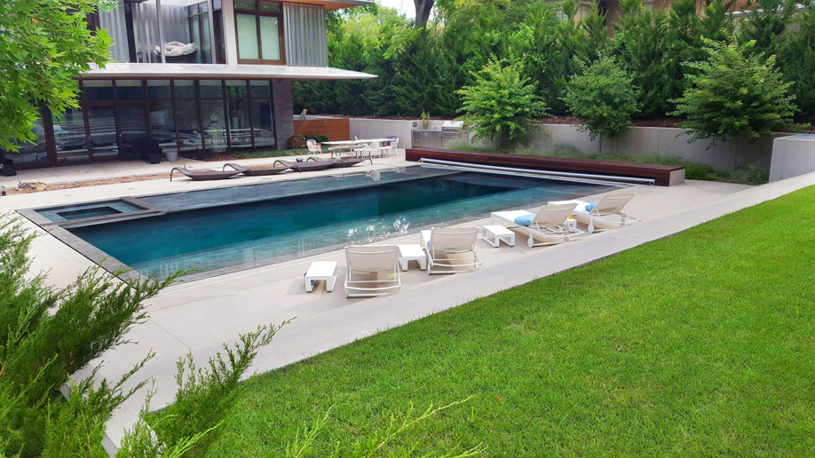 A modern infinity-edge pool with an integrated spa by Midwest Custom Pools, LLC in Lawrence, KS.