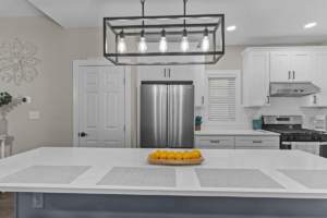 A modern kitchen featuring a stylish chandelier, expertly installed by SE Brown Co. LLC in West Grove, PA.