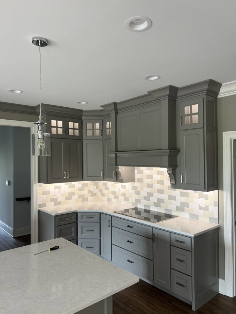 A modern kitchen featuring stylish pendant and recessed lighting installed by Ace Electrical Services LLC in Owensboro, KY.