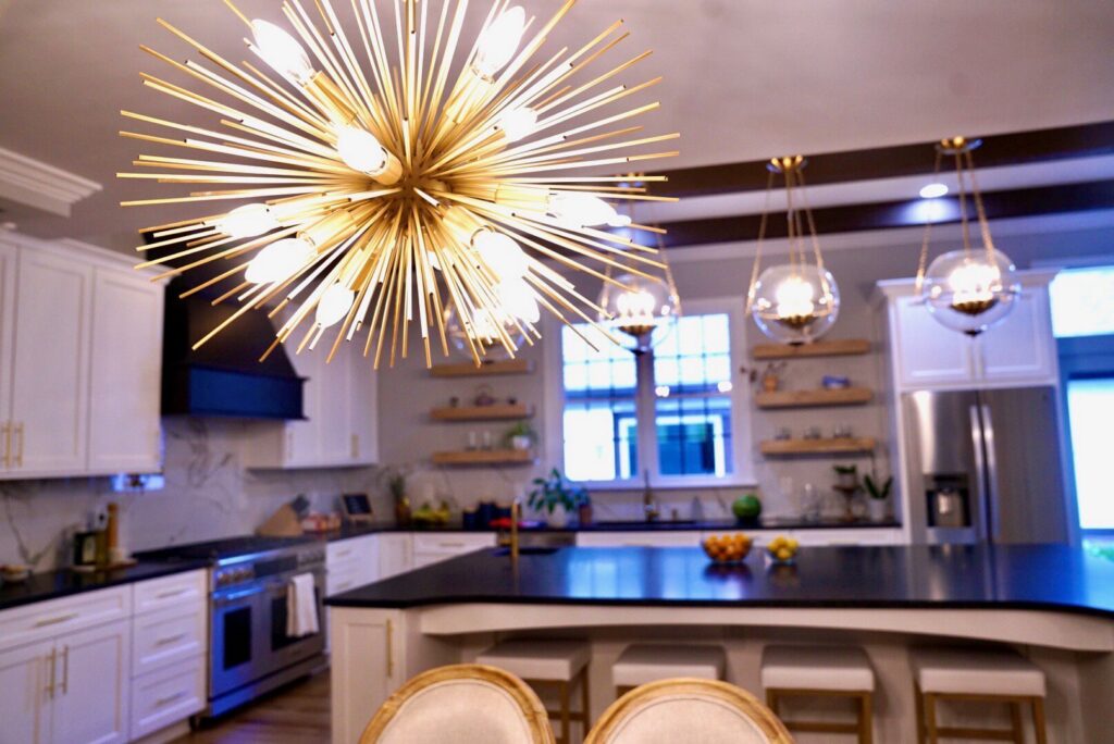 Modern kitchen lighting, including a chandelier and pendant lights, installed by All Connected Electric LLC in Raleigh, NC.