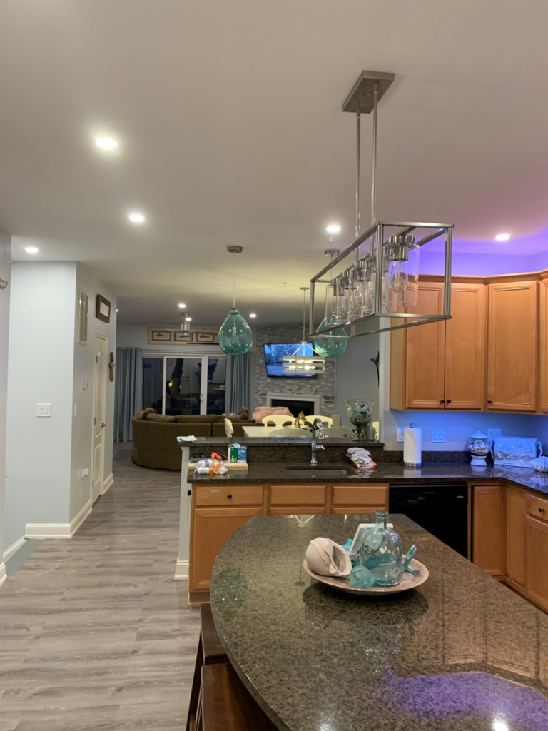 Modern kitchen and living area with new lighting installation by Hawkins Electric Service, Inc. in Laurel, MD.