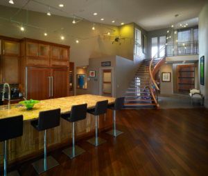 A modern kitchen and living area showcasing professional lighting installation by Obot Electric in Bellevue, WA