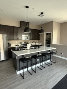 A modern kitchen showcasing new pendant lights installed over the island by G5 Electric, LLC in Evansville, IN.