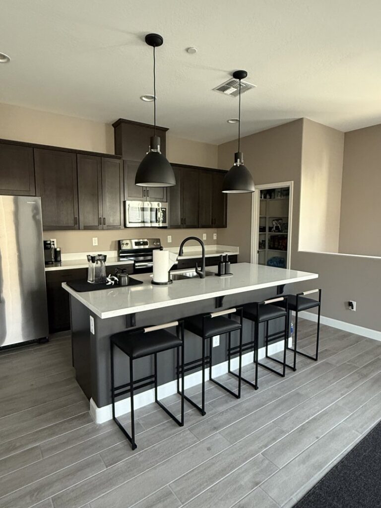 A modern kitchen showcasing new pendant lights installed over the island by G5 Electric, LLC in Evansville, IN.