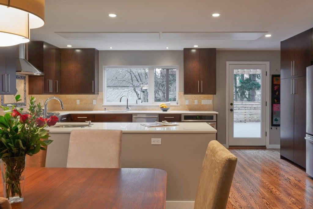 A modern kitchen featuring energy-efficient ceiling radiant heating and cooling panels installed by Mighty Energy Solutions in Seattle, WA.
