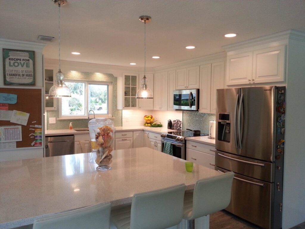 A modern kitchen featuring recessed and pendant lighting installed by McCall Enterprises in Atlanta, GA.