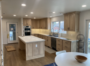 A modern kitchen showcasing new recessed and under-cabinet lighting installed by Skousen Electric LLC in Sandy, UT.