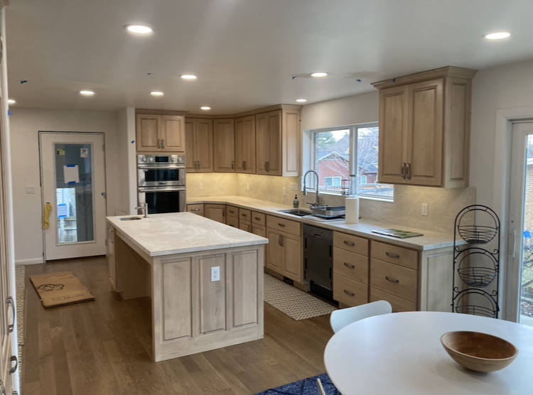 A modern kitchen showcasing new recessed and under-cabinet lighting installed by Skousen Electric LLC in Sandy, UT.