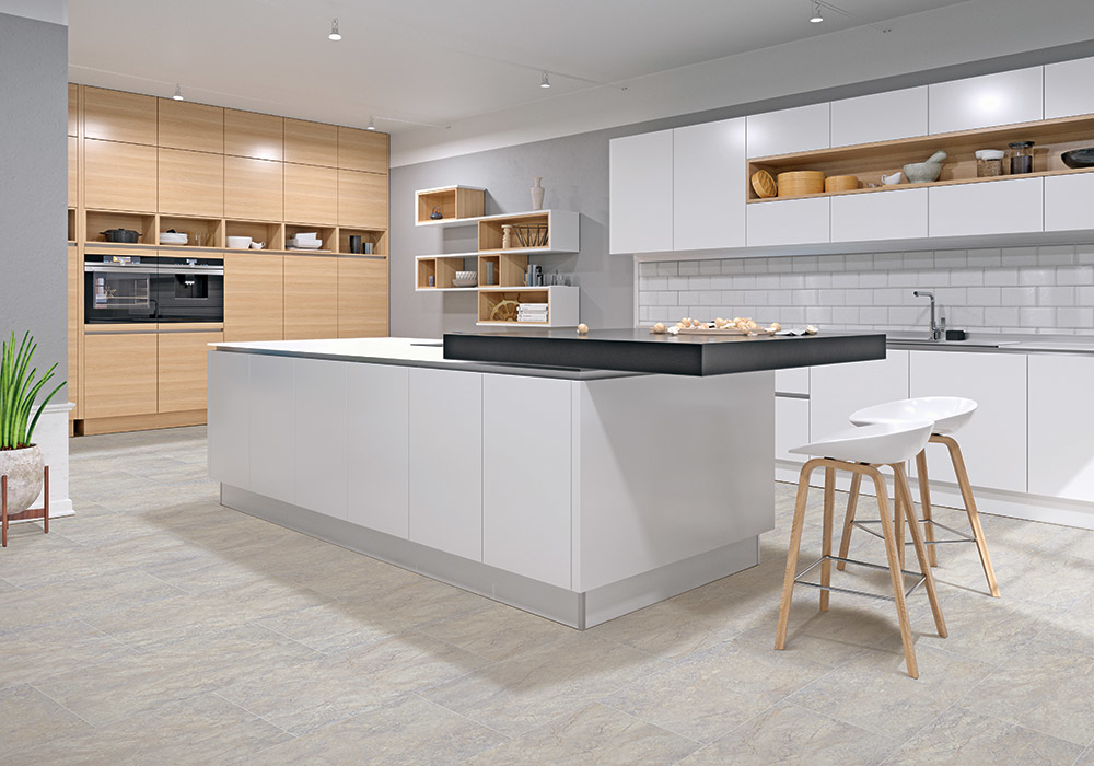 A modern kitchen showcasing new tile flooring installed by Carpet Warehouse and Color Tile in Coeur d'Alene, ID.