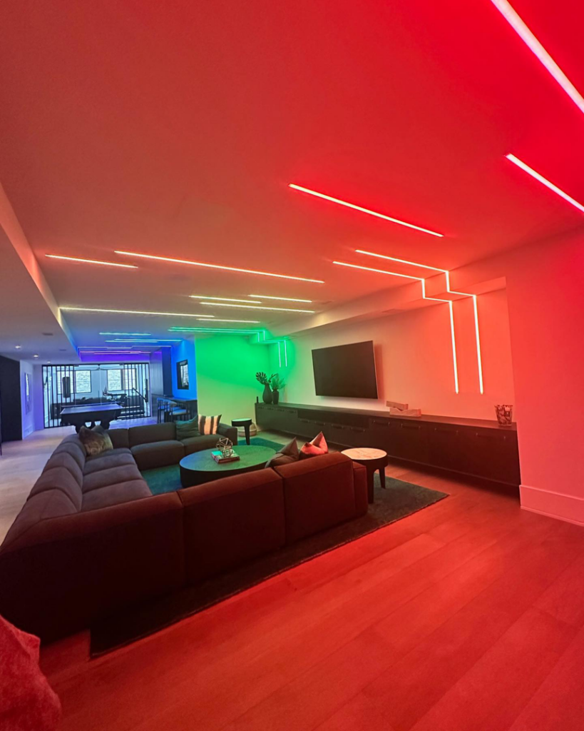 A modern living room featuring custom colorful LED strip lighting installed by R + R Energy/Automation in La Grange, IL.