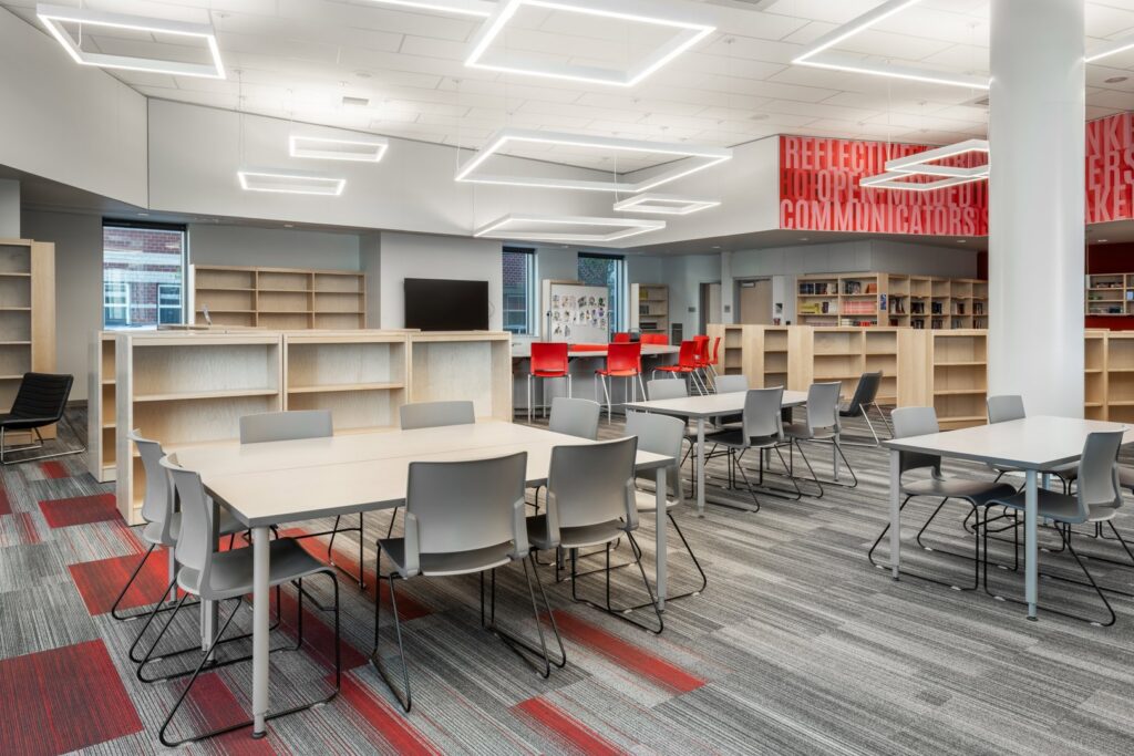 A modern library interior showcasing a vibrant carpet tile installation by Capital Carpet & Flooring Specialists in Wilmington, MA