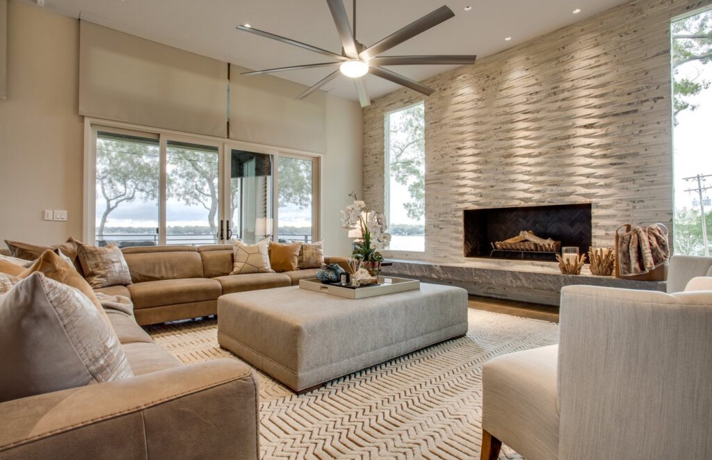 A modern living room featuring a large, light-colored area rug, expertly installed by Dallas Rugs in Dallas, TX.