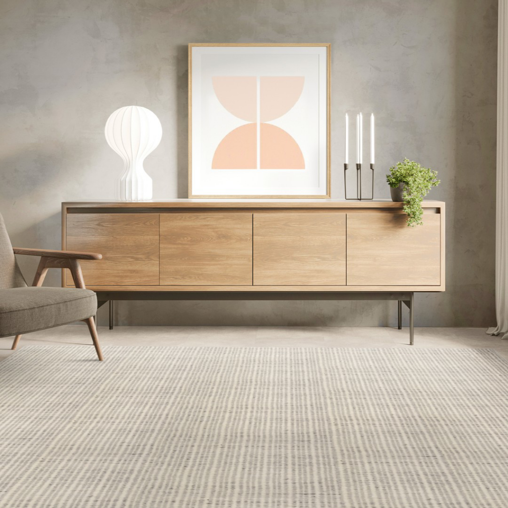 A modern living room featuring a light-colored striped carpet installed by Carpet World Fargo, ND