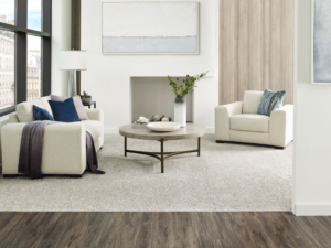 A modern living room featuring a freshly installed light grey carpet by PCS Flooring LLC in Appleton, WI.
