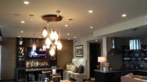 Modern living room and bar area showcasing various lighting installations by Christensen Electric in Galveston, TX.