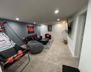 A modern living room featuring bright recessed lighting installed by Black Power Redevelopers in Papillion, NE.