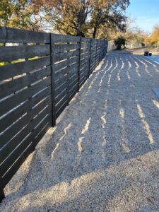 A modern metal gate featuring a secure keypad lock, installed by Ft Worth Fence And Patio in Fort Worth, TX.