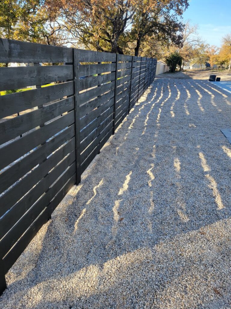 A modern metal gate featuring a secure keypad lock, installed by Ft Worth Fence And Patio in Fort Worth, TX.