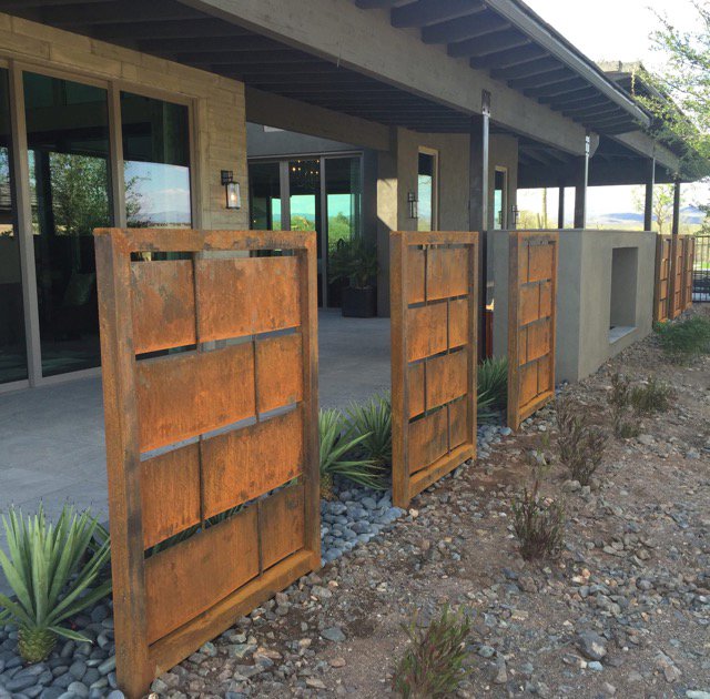 Modern metal privacy panels installed along a patio area by Fence Company Tucson in Tucson, AZ.