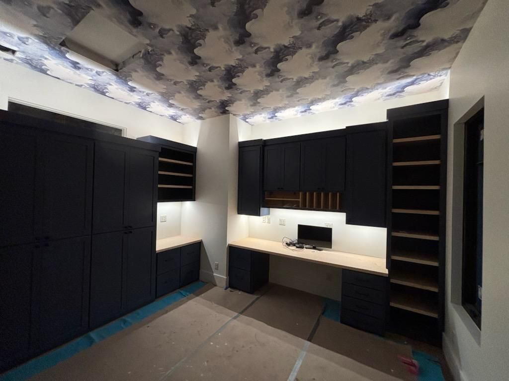 A modern office with built-in cabinetry, featuring under-cabinet and recessed ceiling lighting installed by SEI Electric Inc. in Idaho Falls, ID.
