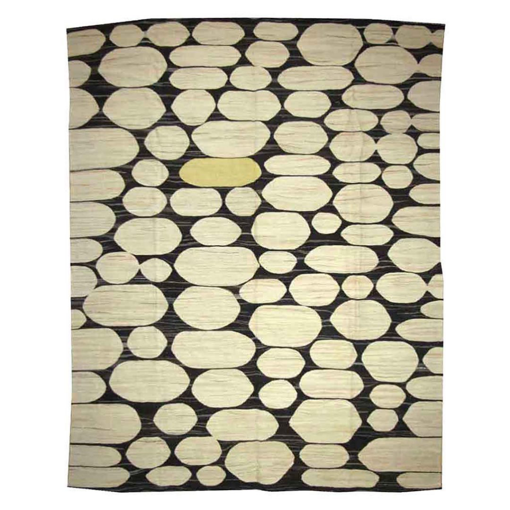A full view of a modern rug with a black background and light oval patterns, offered by Legacy Looms in Minneapolis, MN.