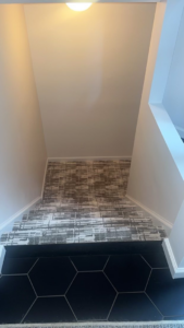 A modern patterned stair runner installation by Christie Carpets & Blinds, a carpet contractor in Rochester, NY