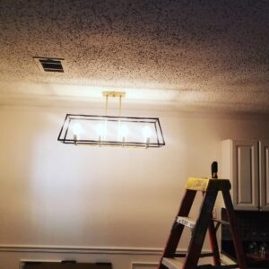 A modern rectangular chandelier newly installed in a room, indicating electrical work by Ponce Electric in Houston, TX