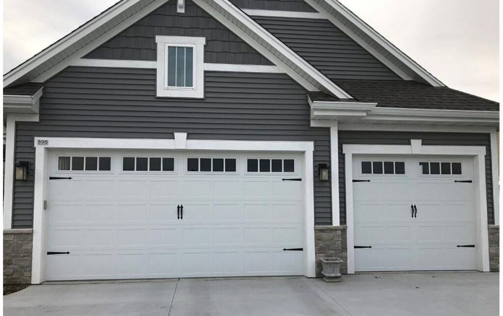 Two modern residential garage doors with decorative hardware and windows, installed by Geiszler Garage Door in Milwaukee, WI.
