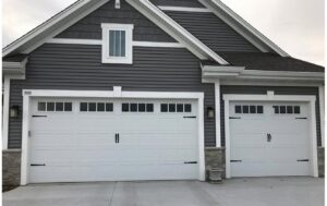 Two modern residential garage doors with decorative hardware and windows, installed by Geiszler Garage Door in Milwaukee, WI.