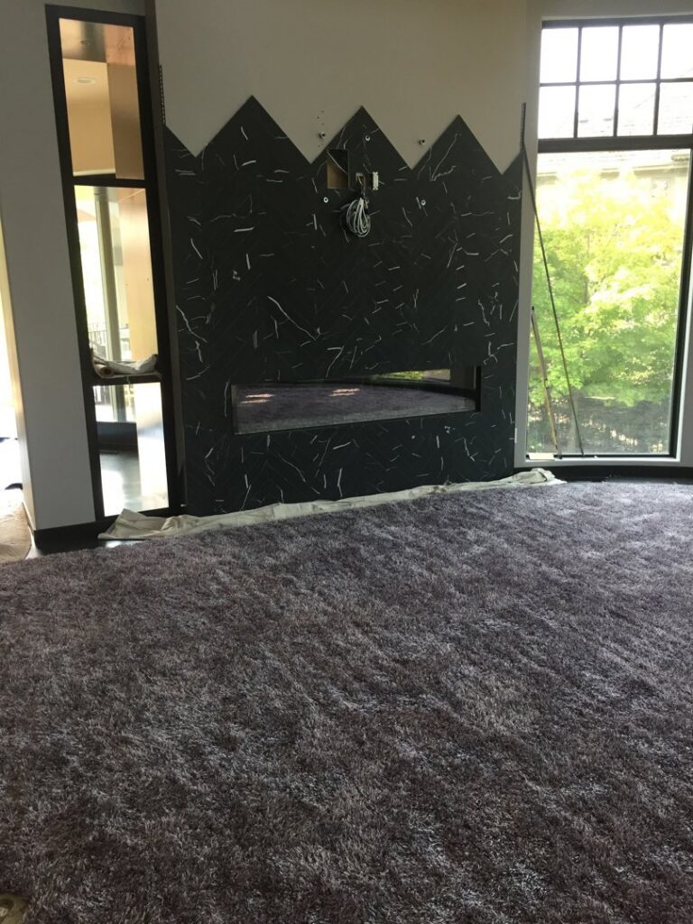 A modern room featuring dark grey shag carpet installed by Infinite Floors Kitchens Bathrooms in Burnsville, MN